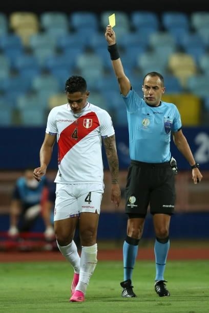Referee Esteban Ostojich shows a yellow card to Ánderson Santamaría of Peru during a quarterfinal match between Peru and Paraguay as part of Copa...