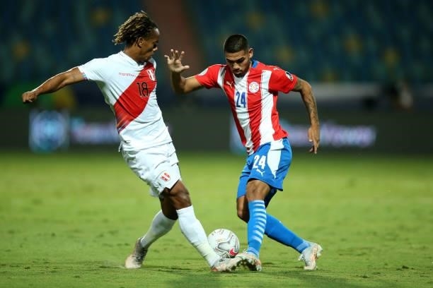 Hector Martinez of Paraguay fights for the ball with André Carrillo of Peru during a quarterfinal match between Peru and Paraguay as part of Copa...