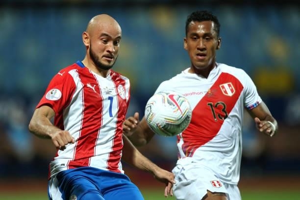 Carlos Gonzalez of Paraguay kicks the ball against Renato Tapia of Peru during a quarterfinal match between Peru and Paraguay as part of Copa America...