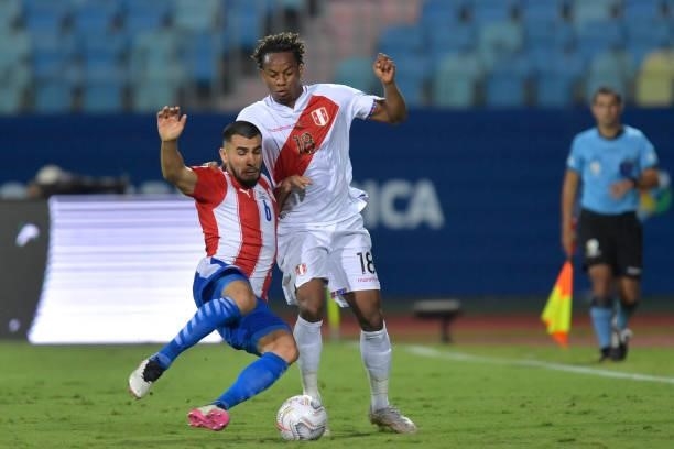 André Carrillo of Peru fights for the ball with Junior Alonso of Paraguay during a quarterfinal match between Peru and Paraguay as part of Copa...