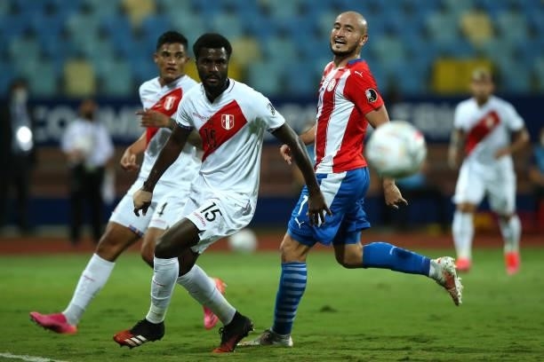 Christian Ramos of Peru and Carlos Gonzalez of Paraguay run after the ball during a quarterfinal match between Peru and Paraguay as part of Copa...