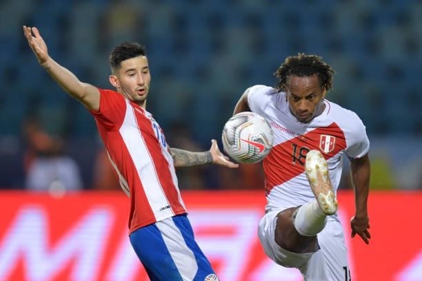 André Carrillo of Peru kicks the ball against Mathias Villasanti of Paraguay during a quarterfinal match between Peru and Paraguay as part of Copa...