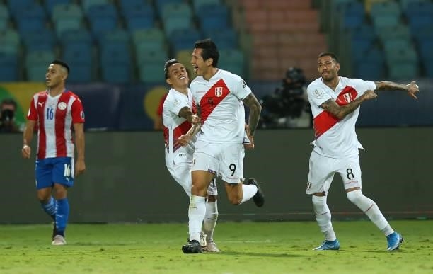 Gianluca Lapadula of Peru celebrates with teammates Christian Cueva and Sergio Peña after scoring the second goal of his team during a quarterfinal...