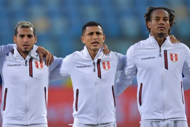 Miguel Trauco, Yoshimar Yotún, and André Carrillo of Peru sing the national anthem prior to a quarterfinal match between Peru and Paraguay as part of...