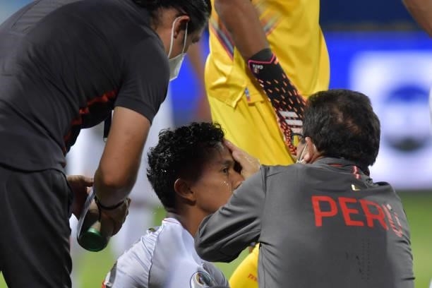 Renato Tapia of Peru receives medical attention after suffering an injury during a quarterfinal match between Peru and Paraguay as part of Copa...
