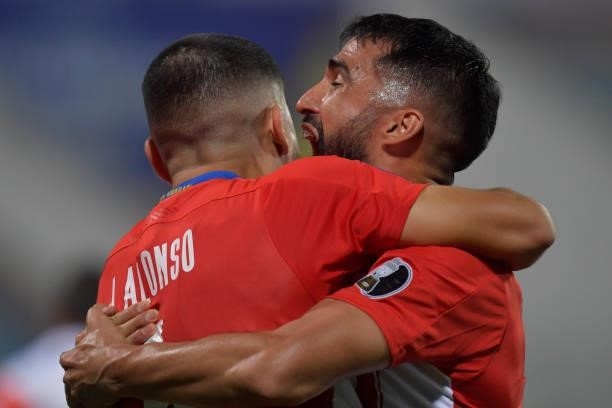 Junior Alonso of Paraguay celebrates with teammate Alberto Espinola after scoring the second goal of his team during a quarterfinal match between...