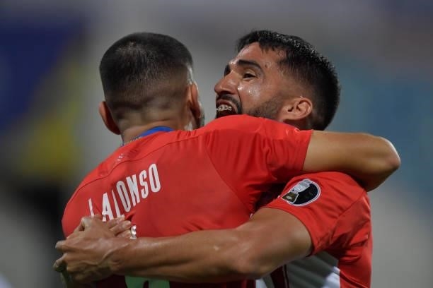 Junior Alonso of Paraguay celebrates with teammate Alberto Espinola after scoring the second goal of his team during a quarterfinal match between...