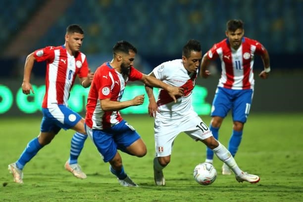 Christian Cueva of Peru fights for the ball with Alberto Espinola of Paraguay during a quarterfinal match between Peru and Paraguay as part of Copa...