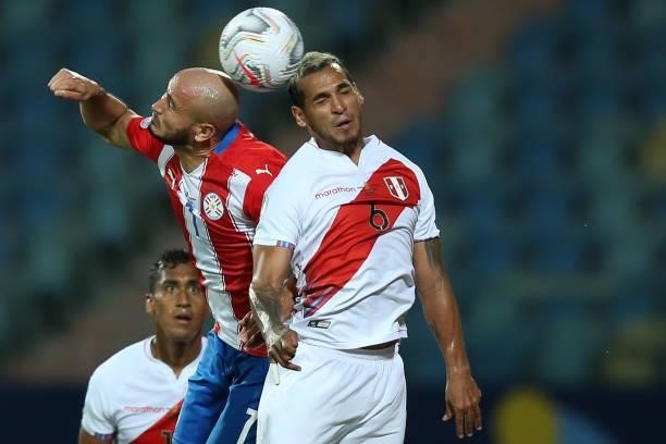 Carlos Gonzalez of Paraguay heads the ball against Miguel Trauco of Peru during a quarterfinal match between Peru and Paraguay as part of Copa...