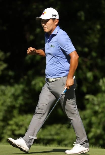 Sung Kang of South Korea reacts to his birdie putt on the eighth green during the second round of the Rocket Mortgage Classic on July 02, 2021 at the...