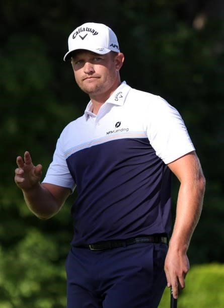 Tom Lewis of England reacts to his putt on the ninth green during the second round of the Rocket Mortgage Classic on July 02, 2021 at the Detroit...