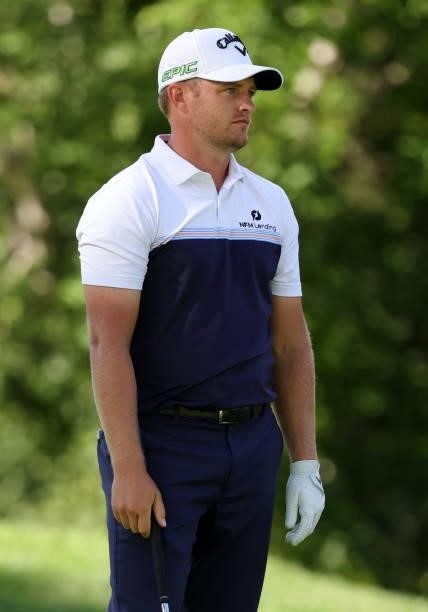Tom Lewis of England reacts to his shot on the ninth tee during the second round of the Rocket Mortgage Classic on July 02, 2021 at the Detroit Golf...