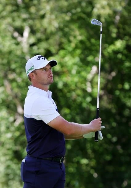 Tom Lewis of England rplays his shot from the ninth tee during the second round of the Rocket Mortgage Classic on July 02, 2021 at the Detroit Golf...