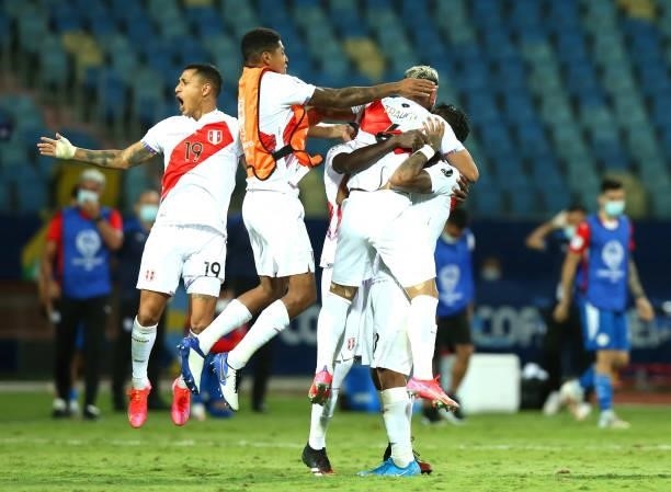 Miguel Trauco of Peru celebrates with teammates winning the match in a penalty shootout after a quarterfinal match between Peru and Paraguay as part...