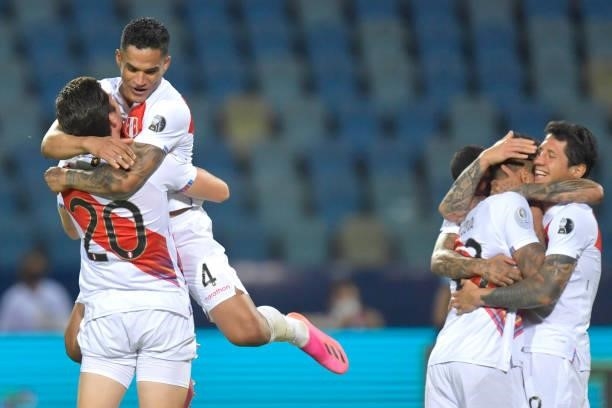 Santiago Ormeño of Peru celebrates with teammate Ánderson Santamaría winning the match in a penalty shootout after a quarterfinal match between Peru...