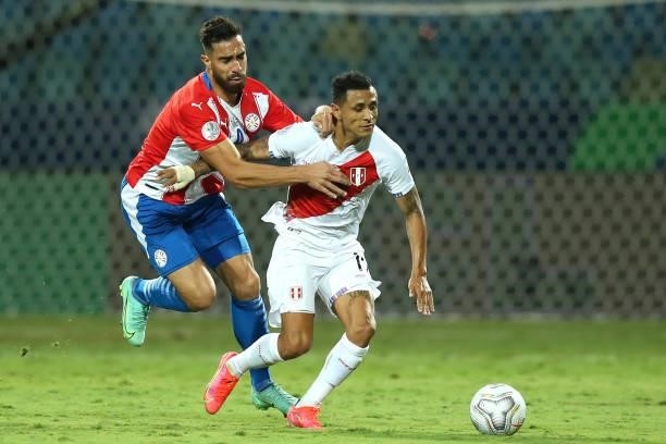 Yoshimar Yotún of Peru fights for the ball with Gabriel Avalos of Paraguay during a quarterfinal match between Peru and Paraguay as part of Copa...