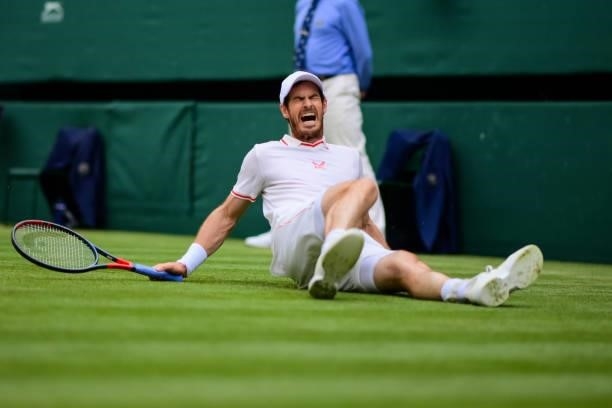 Andy Murray of Great Britain slips over on the grass during his match against Dennis Shapovalov of Canada in the third round of the gentlemen's...