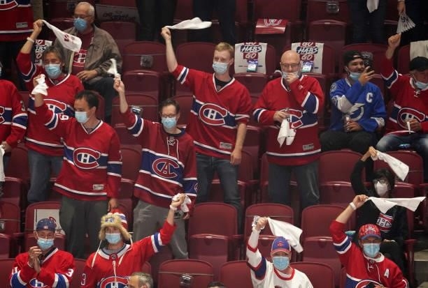 Fans cheer during warmups prior to Game Three of the 2021 NHL Stanley Cup Final between the Tampa Bay Lightning and the Montreal Canadiens at Bell...