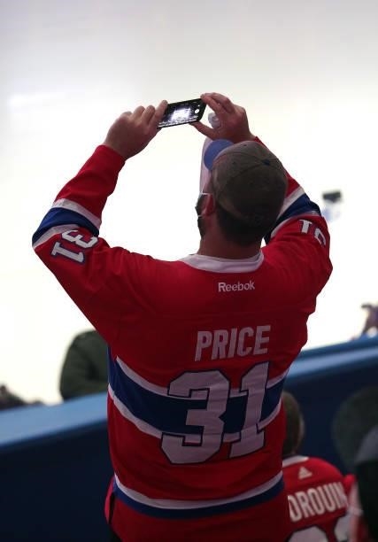 Fan takes a photo on his iPhone prior to Game Three of the 2021 NHL Stanley Cup Final between the Tampa Bay Lightning and the Montreal Canadiens at...