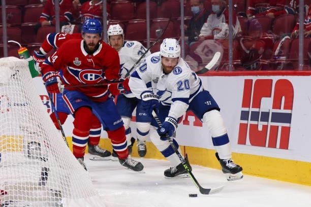 Blake Coleman of the Tampa Bay Lightning controls the puck defended by Nick Suzuki of the Montreal Canadiens during the first period in Game Three of...