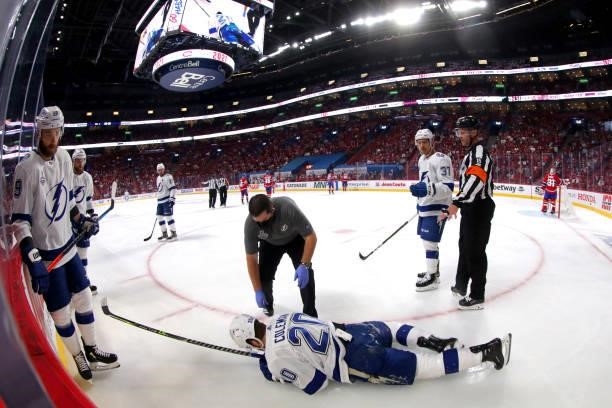 Blake Coleman of the Tampa Bay Lightning sustains an injury against the Montreal Canadiens during the first period in Game Three of the 2021 NHL...