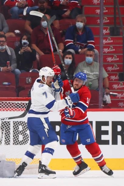 Mathieu Joseph of the Tampa Bay Lightning and Brendan Gallagher of the Montreal Canadiens mix it up during the first period in Game Three of the 2021...