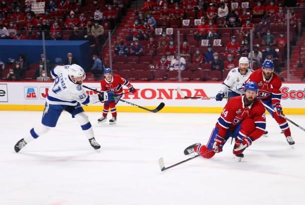 Joel Edmundson of the Montreal Canadiens attempts to block a shot against Erik Cernak of the Tampa Bay Lightning during the first period in Game...