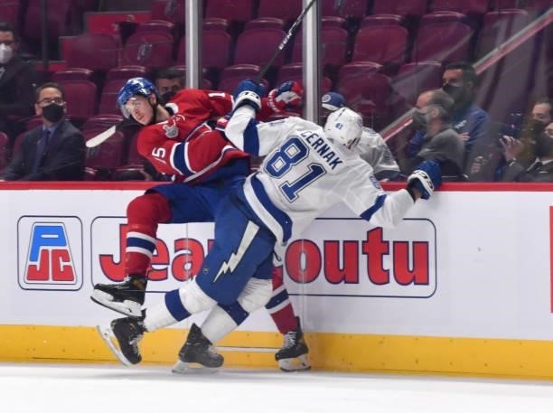 Erik Cernak of the Tampa Bay Lightning collides with Jesperi Kotkaniemi of the Montreal Canadiens during the first period in Game Three of the 2021...