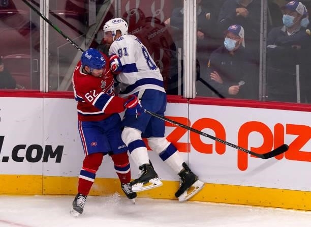 Erik Cernak of the Tampa Bay Lightning checks Artturi Lehkonen of the Montreal Canadiens during the first period in Game Three of the 2021 NHL...