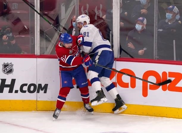 Erik Cernak of the Tampa Bay Lightning checks Artturi Lehkonen of the Montreal Canadiens during the first period in Game Three of the 2021 NHL...