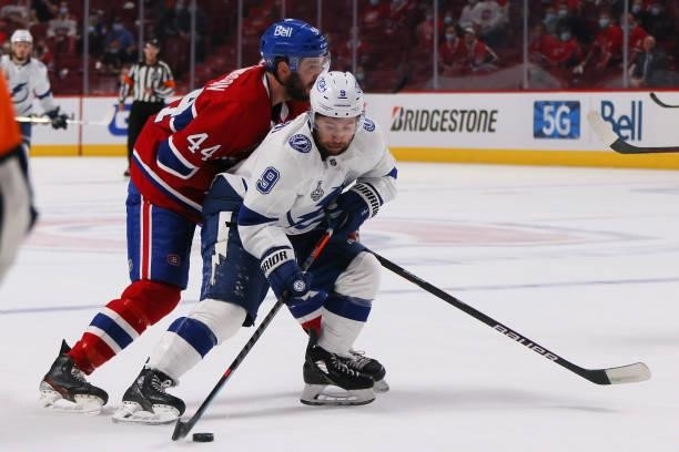 Tyler Johnson of the Tampa Bay Lightning is defended by Joel Edmundson of the Montreal Canadiens during the first period in Game Three of the 2021...