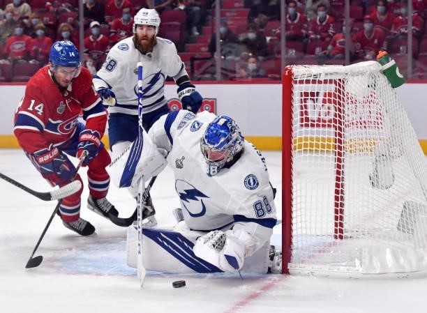 Andrei Vasilevskiy of the Tampa Bay Lightning tends goal as Nick Suzuki of the Montreal Canadiens looks to attach during the first period in Game...