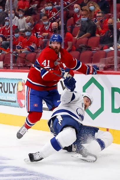 Paul Byron of the Montreal Canadiens checks Barclay Goodrow of the Tampa Bay Lightning during the first period in Game Three of the 2021 NHL Stanley...