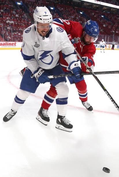 Erik Gustafsson of the Montreal Canadiens battles for the puck against Mathieu Joseph of the Tampa Bay Lightning during the first period of Game...