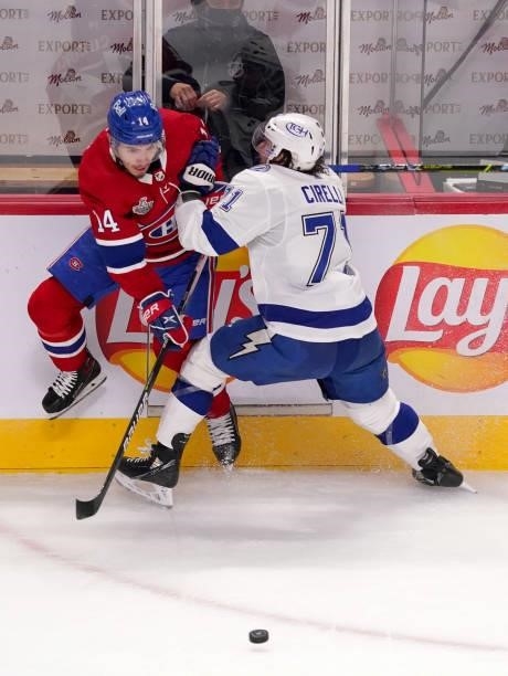 Nick Suzuki of the Montreal Canadiens is checked by Anthony Cirelli of the Tampa Bay Lightning during the first period in Game Three of the 2021 NHL...