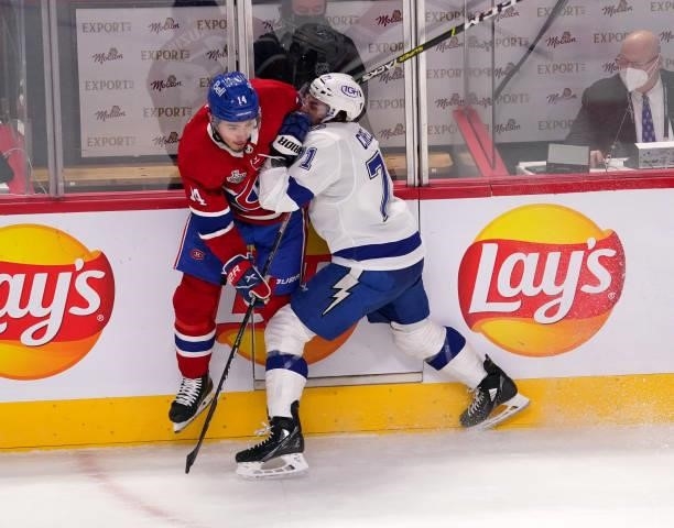 Nick Suzuki of the Montreal Canadiens is checked by Anthony Cirelli of the Tampa Bay Lightning during the first period in Game Three of the 2021 NHL...