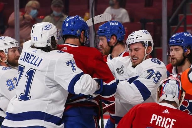 Shea Weber of the Montreal Canadiens fights with Ross Colton and Anthony Cirelli of the Tampa Bay Lightning during the first period in Game Three of...