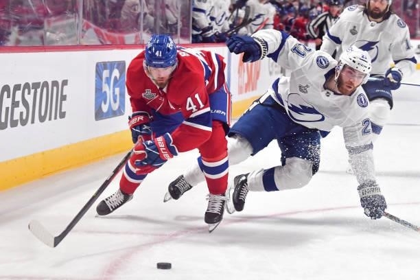 Paul Byron of the Montreal Canadiens looks to take control of the puck defended by Brayden Point of the Tampa Bay Lightning during the first period...