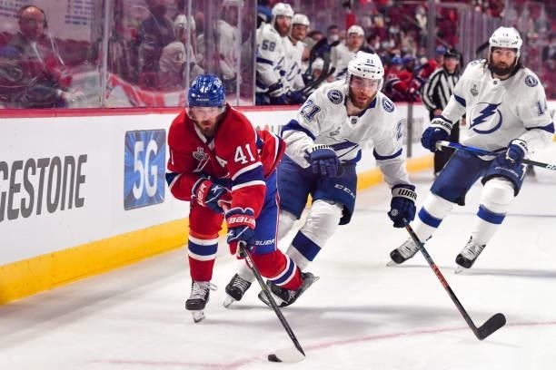 Paul Byron of the Montreal Canadiens looks to take control of the puck defended by Brayden Point of the Tampa Bay Lightning during the first period...