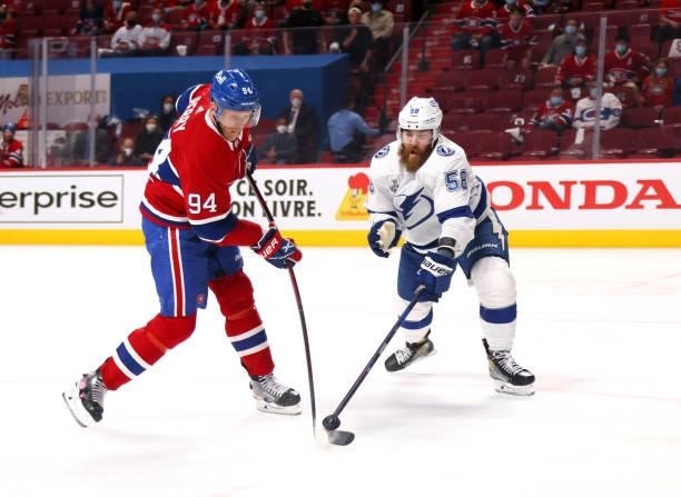 David Savard of the Tampa Bay Lightning defends a shot from Corey Perry of the Montreal Canadiens during the second period in Game Three of the 2021...