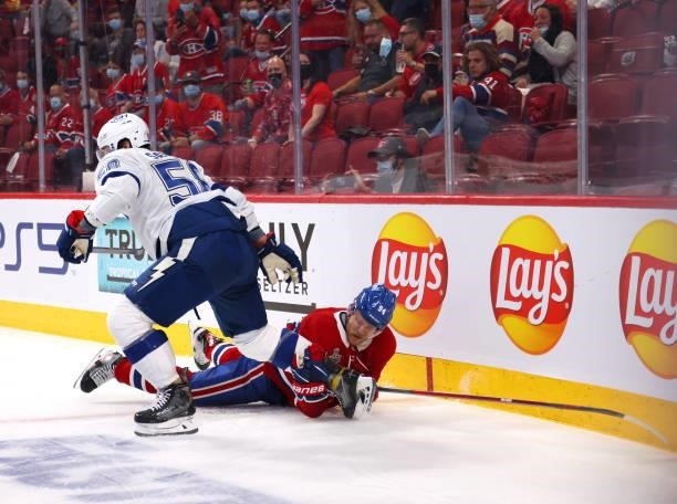 Corey Perry of the Montreal Canadiens grabs a hold of a skate of David Savard of the Tampa Bay Lightning during the second period in Game Three of...