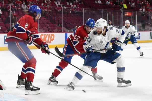 Artturi Lehkonen of the Montreal Canadiens and Brayden Point of the Tampa Bay Lightning battle for the puck during the first period in Game Three of...