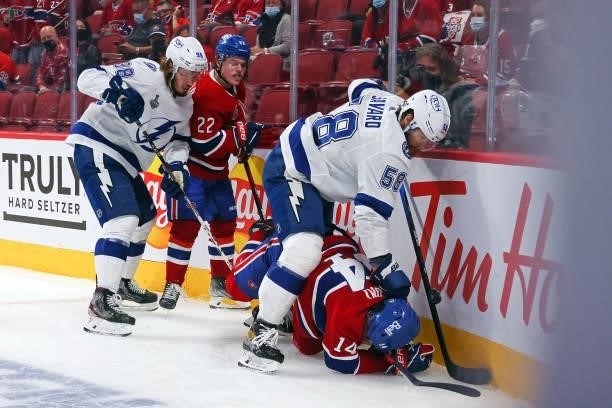 David Savard of the Tampa Bay Lightning pushes over Nick Suzuki of the Montreal Canadiens during the second period in Game Three of the 2021 NHL...