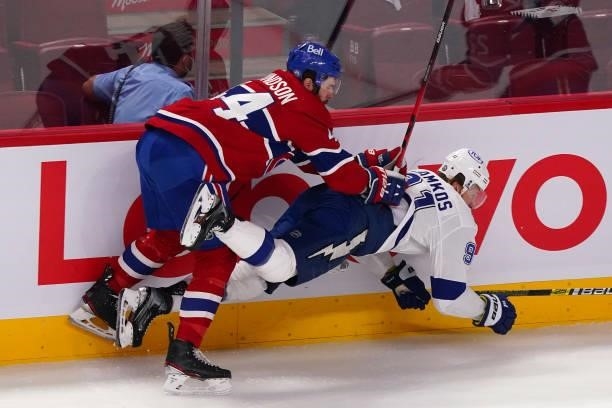 Steven Stamkos of the Tampa Bay Lightning is checked by Joel Edmundson of the Montreal Canadiens during the first period in Game Three of the 2021...