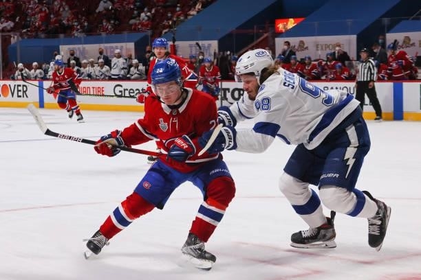 Mikhail Sergachev of the Tampa Bay Lightning collides with Cole Caufield of the Montreal Canadiens during the second period in Game Three of the 2021...