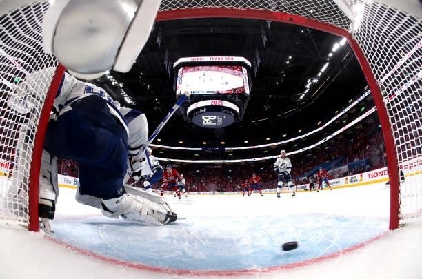 The puck goes into the net past goaltender Andrei Vasilevskiy of the Tampa Bay Lightning on a goal by Nick Suzuki of the Montreal Canadiens during...