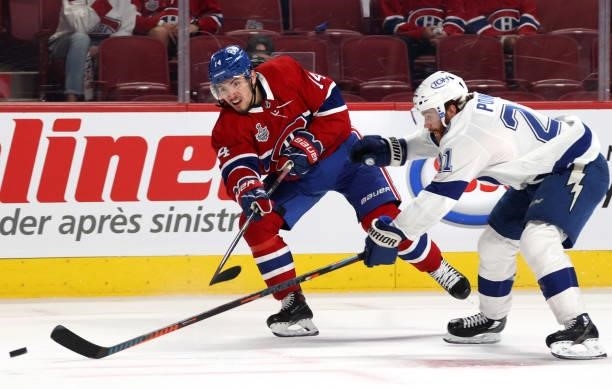 Nick Suzuki of the Montreal Canadiens takes a shot past Brayden Point of the Tampa Bay Lightning to score a goal during the second period of Game...