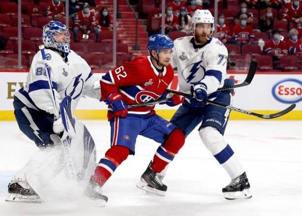 Artturi Lehkonen of the Montreal Canadiens is defended by Victor Hedman and goaltender Andrei Vasilevskiy of the Tampa Bay Lightning during the...