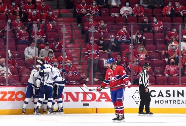 Joel Armia of the Montreal Canadiens looks on as Tyler Johnson of the Tampa Bay Lightning celebrates with teammates after scoring against Carey Price...