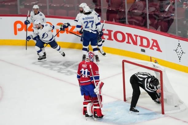 Carey Price of the Montreal Canadiens reacts as Tyler Johnson of the Tampa Bay Lightning celebrates with teammates after scoring during the third...
